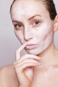 woman’s face filled with white cream