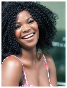 smiling woman in afro hairstyle 